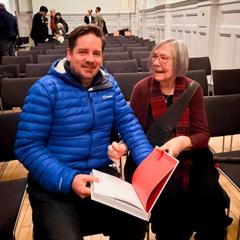 Me sitting on a chair next to Margaret Calvert.