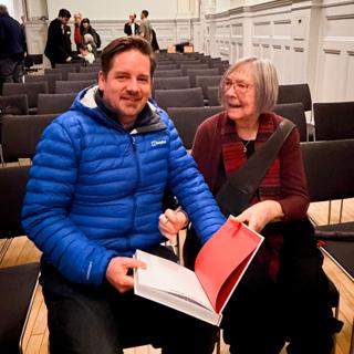 Me sitting on a chair next to Margaret Calvert.