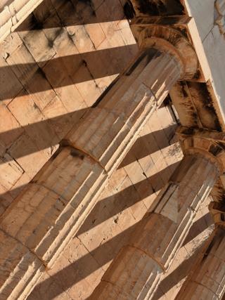 Close up of the colonnades of the Temple of Hephaestus, casting a strong shadow on the inner wall.